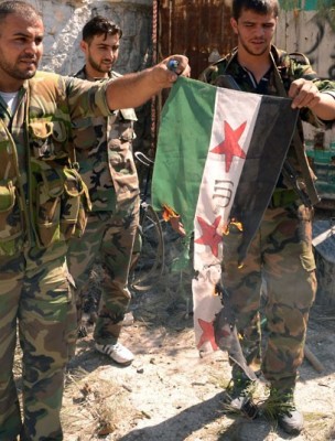 Syrian government troops burn the flag adopted by the rebel forces on September 24, 2012.jpeg